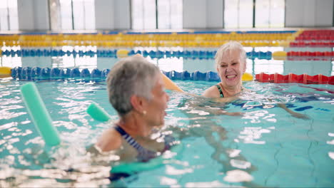 elderly women enjoying aqua aerobics in a swimming pool