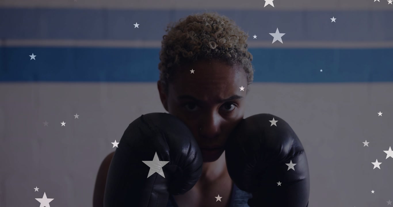 Woman in boxing drill, jabbing camera with black gloves, stars shifting to streaks for fitness