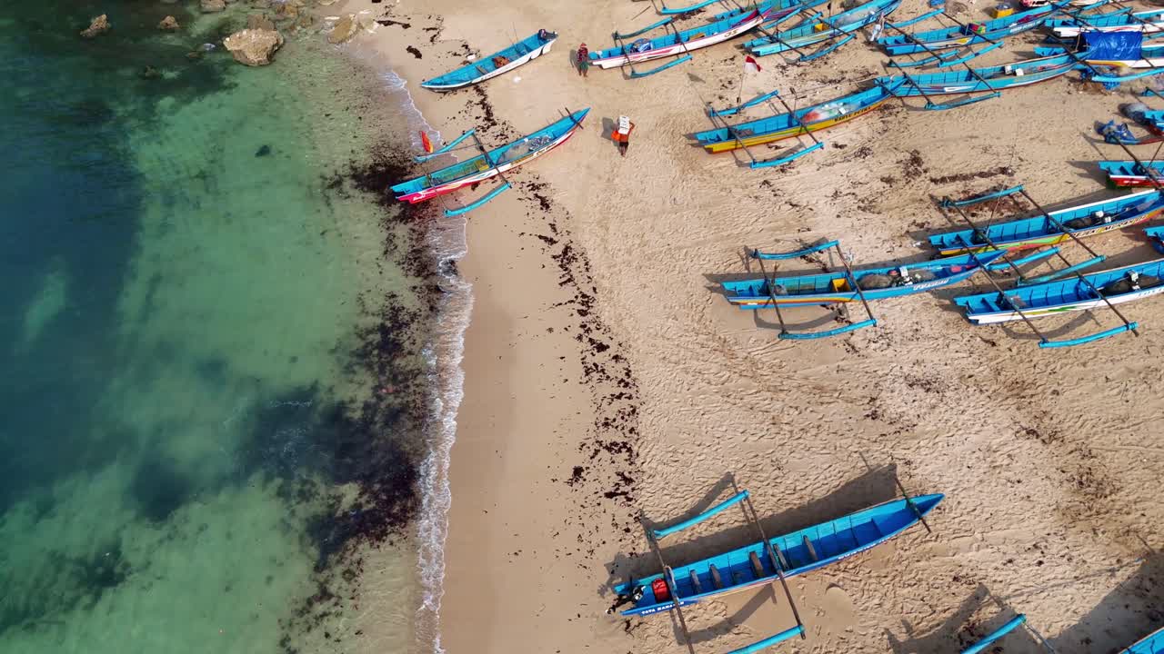 Sandy coast and fishermen boats in Indonesia, aerial view
