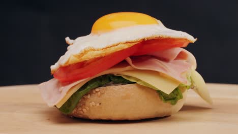bagel sandwich brunch, lunch plate of a bagel with smoked salmon and cream cheese and ham, close up morning cafe menu.