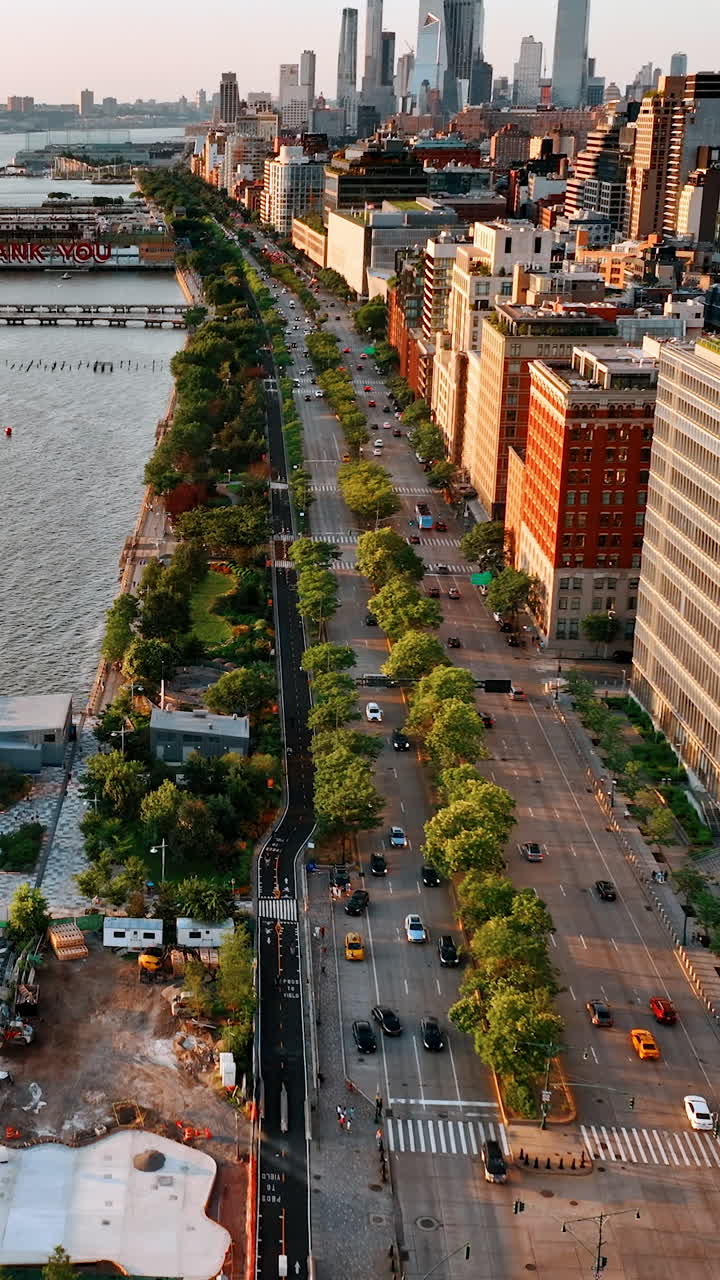 Sight of the lively highway on the river waterfront. View of beautiful New York from aerial perspective. Vertical video