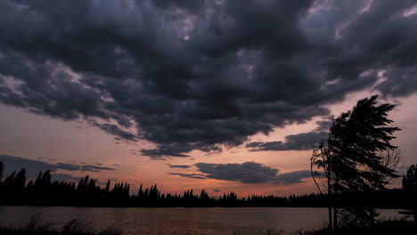dramatic sunset over a lake with storm clouds