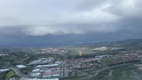 cockpit view of bilbao airport in northern spain during al ils approach runway 30 in a cold, rainy, winter day
