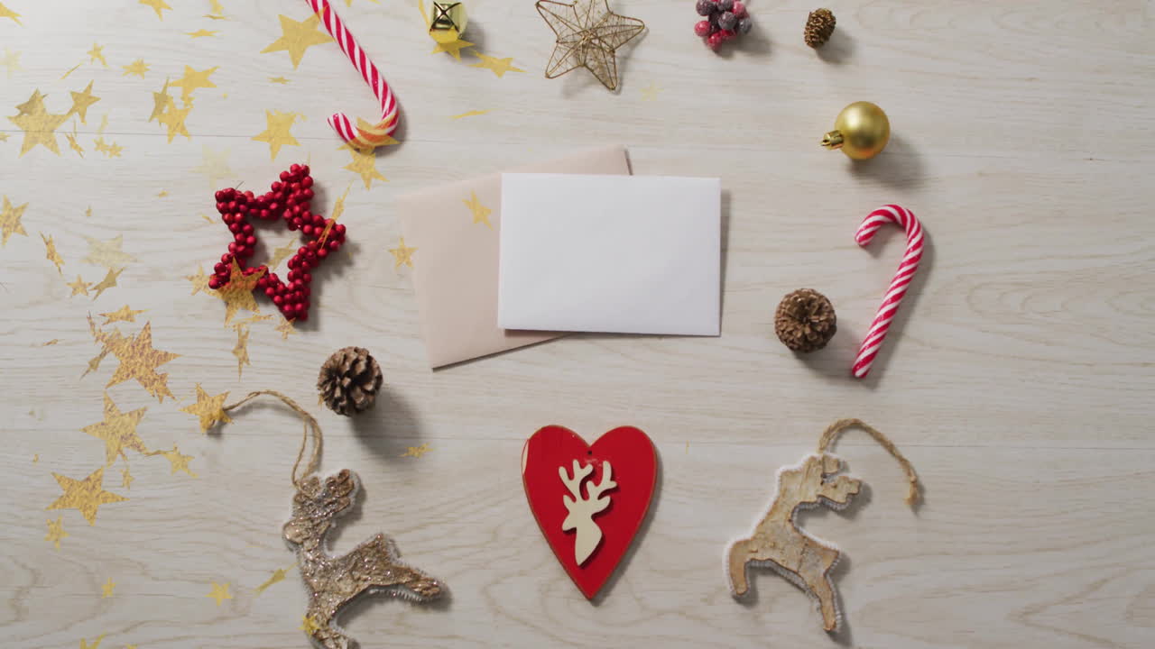 Christmas decorations with cards over star animation on wooden background