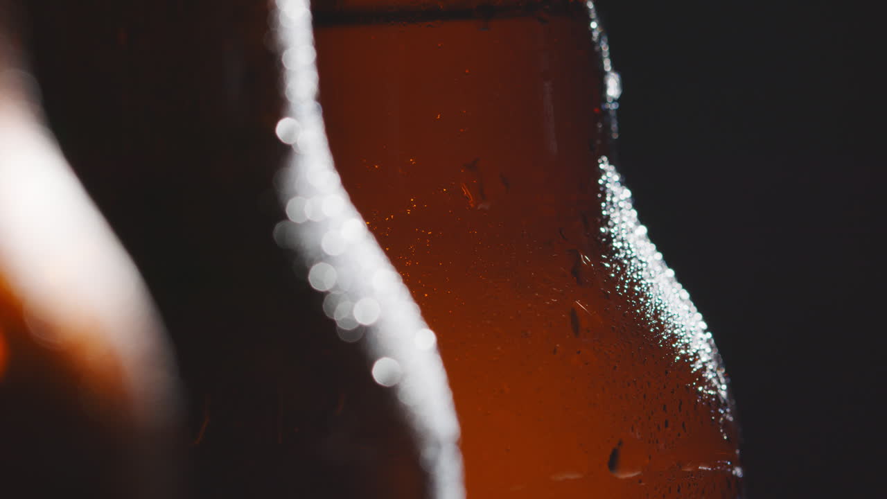 Close Up Of Condensation Droplets On Bottles Of Cold Beer Or Soft Drinks