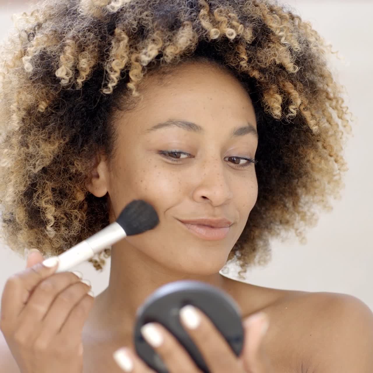 chica con pincel de maquillaje