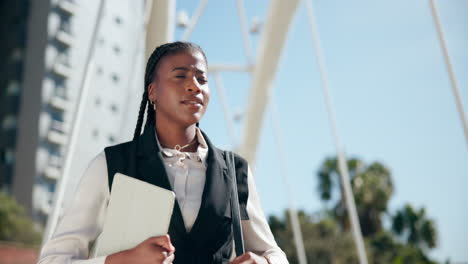 businesswoman checking her watch on a city bridge