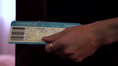 couple holding hands with boarding passes