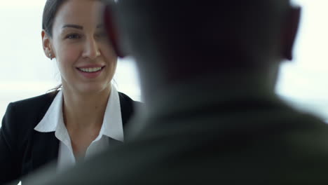 businesswoman in a meeting with coworkers sitting at a table 2