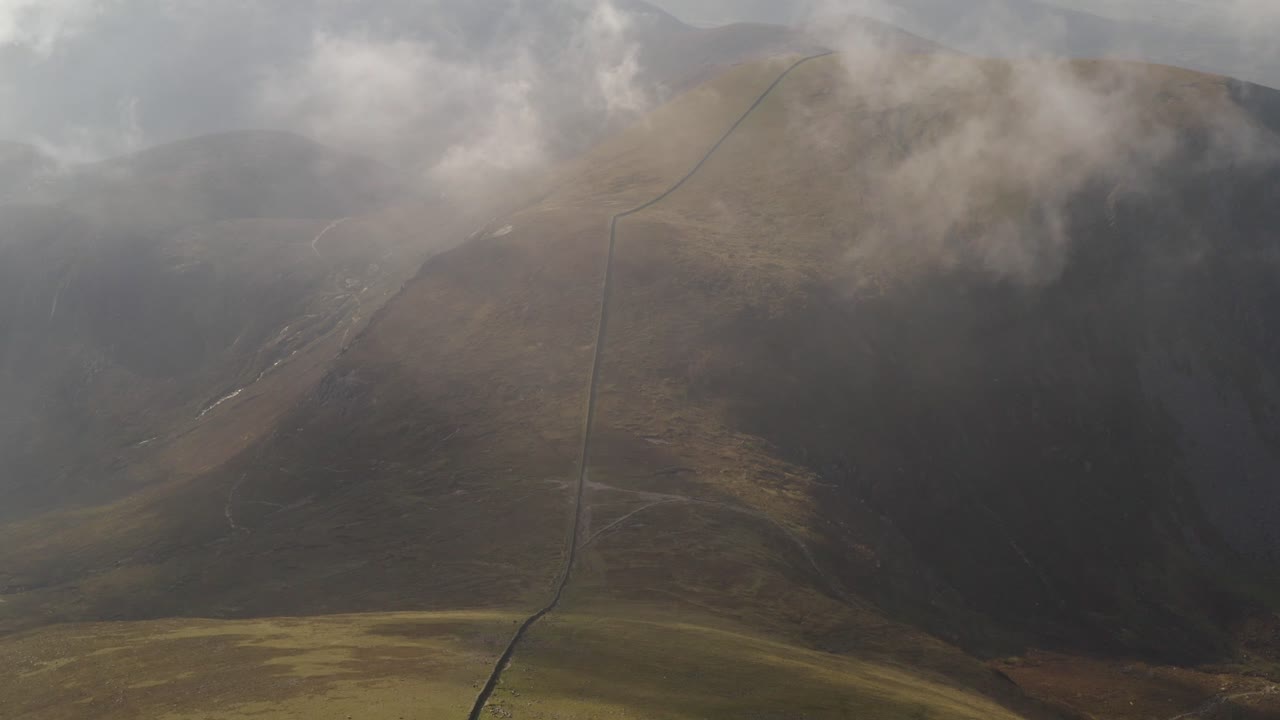 Mourne mountains aerial tilt down reveals Slieve Donard's summit