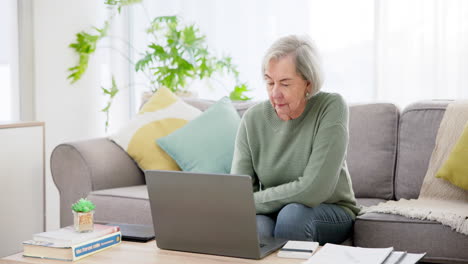 Senior-woman,-laptop-and-budget-on-couch-for-life