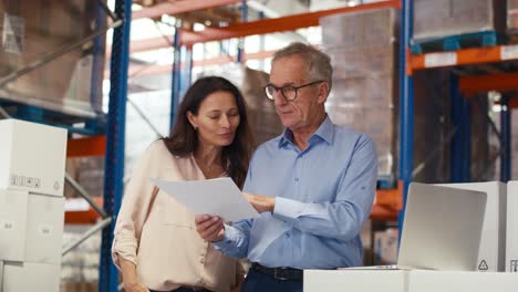 Mature-woman-and-man-working-togetherness-in-the-warehouse.