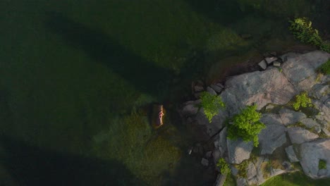 aerial rocket shot of the young women enjoying a summer day on a clear water lake