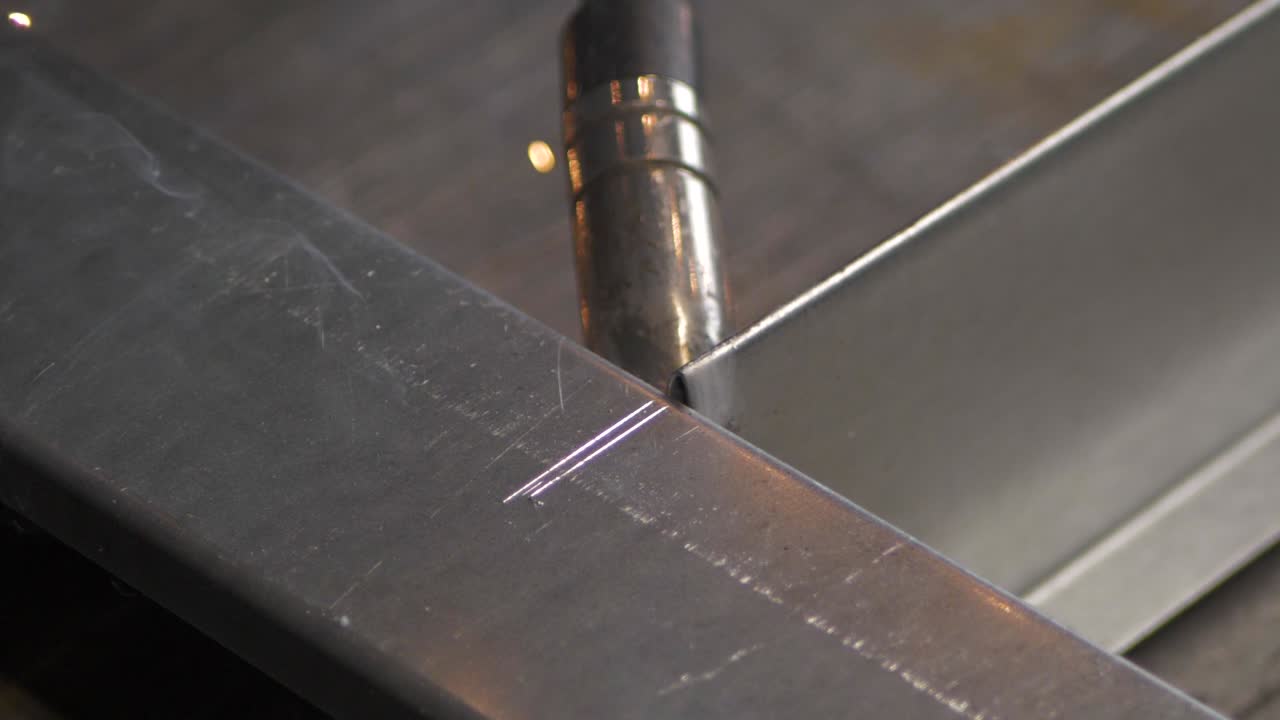 Welder works in metal construction - construction and processing of steel components, slow motion