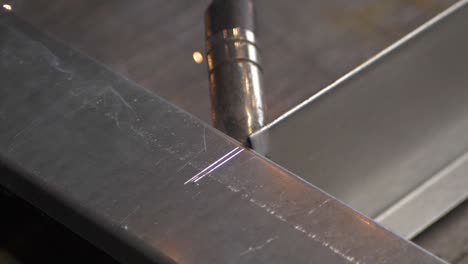 welder works in metal construction - construction and processing of steel components, slow motion