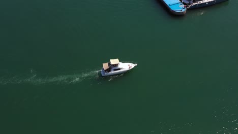 luxury motor yacht sails over the clear green waters of the mediterranean into the marina of herzeliya en route to her mooring place