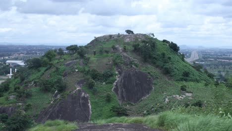 an erected hill in abuja with the trees cover over it