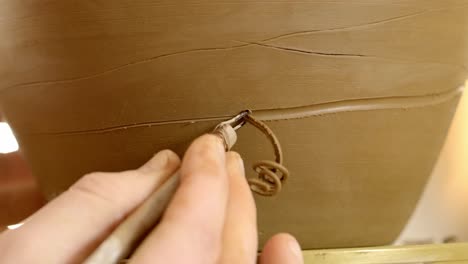 pottery artist shaping clay on wheel