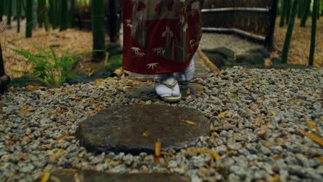 woman in kimono walking in a japanese garden