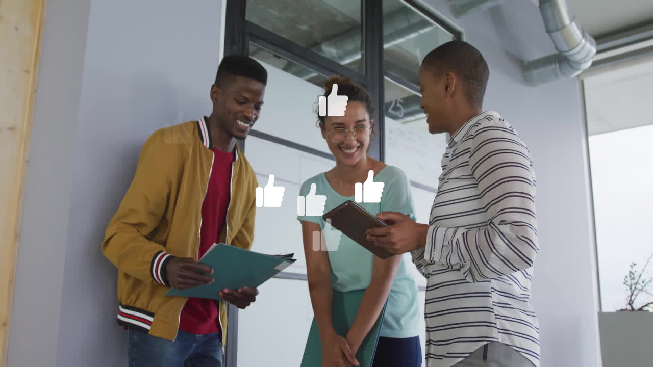 In office, colleagues discussing work while animation of thumbs-up icons floating