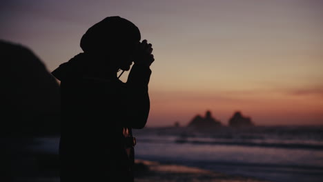 silhouette of photographer at sunset beach