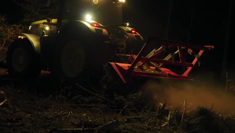 forest mulcher processes tree remains after bark beetle infestation at night