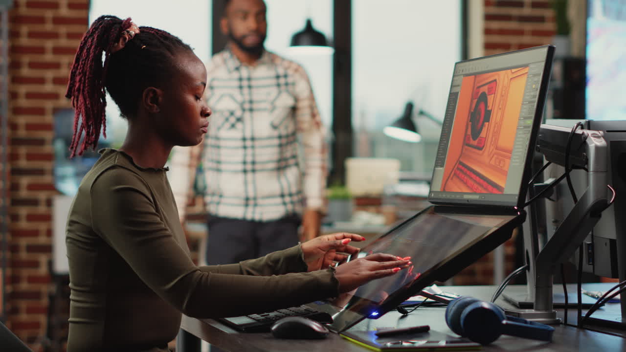 African american woman designing game interface on computer