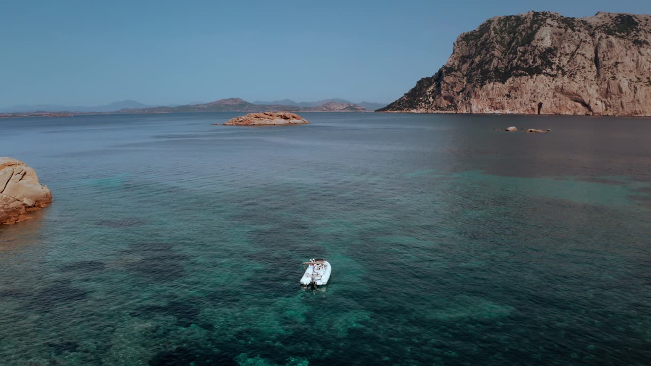Boat in Sardinia close to Tavolara island aerial view by drone