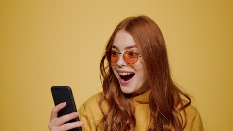 surprised girl getting good news on mobile phone. woman looking cellphone screen