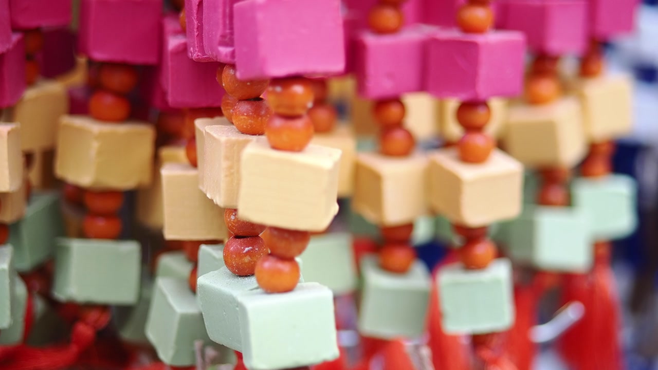 Close-up of Colorful Handmade Cube and Bead Decorations Swaying