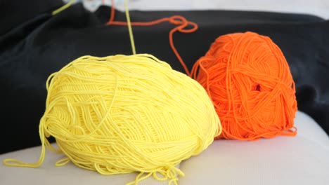 yellow and orange yarn skeins