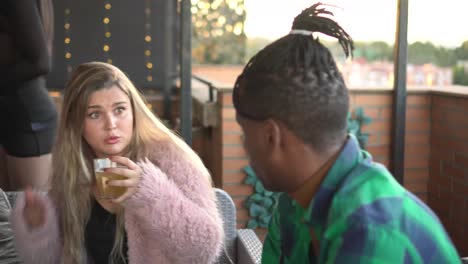 young adults socializing and enjoying drinks at an outdoor party