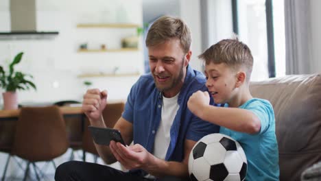 Caucasian-man-and-his-son-sitting-on-a-couch