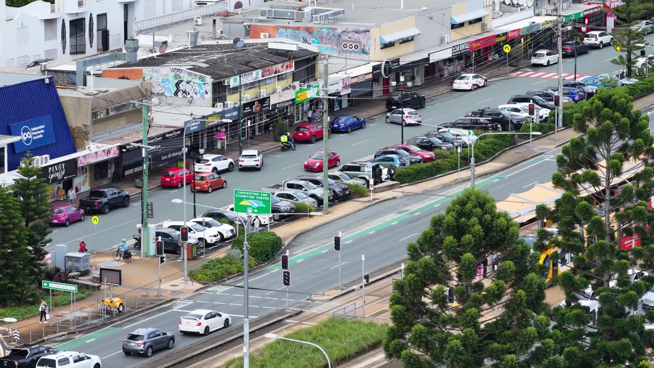 Aerial view of a busy street with shops and traffic in Broadbeach, Gold Coast. Daytime lighting and vibrant urban atmosphere