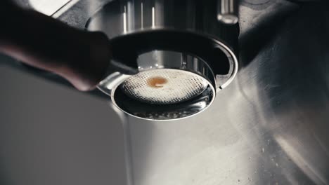 espresso machine macro shot of dripping fresh coffee double shot extraction from bottomless naked portafilter with closeup of last drop using professional equipment at home or cafe in slow motion 4k