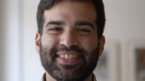 Closeup-view-of-happy-joyful-bearded-guy-posing-indoors