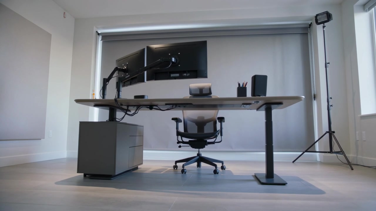 Moving camera zooming on adjustable desk and ergonomic chair at office, revealing cable trays