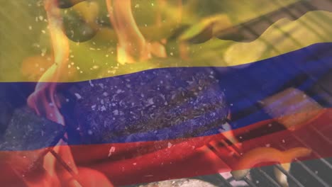 animación de la bandera colombiana ondeando sobre carne y verduras cocinadas en la parrilla de barbacoa.