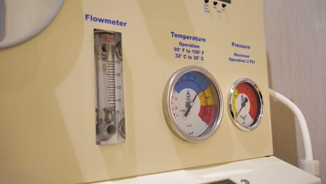 slow motion shot of the different gauges on a colon hydrotherapy machine