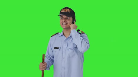 Happy-Indian-security-guard-talking-on-phone-Green-screen