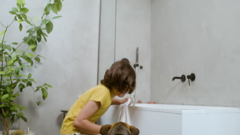 girl and dog at the bathroom