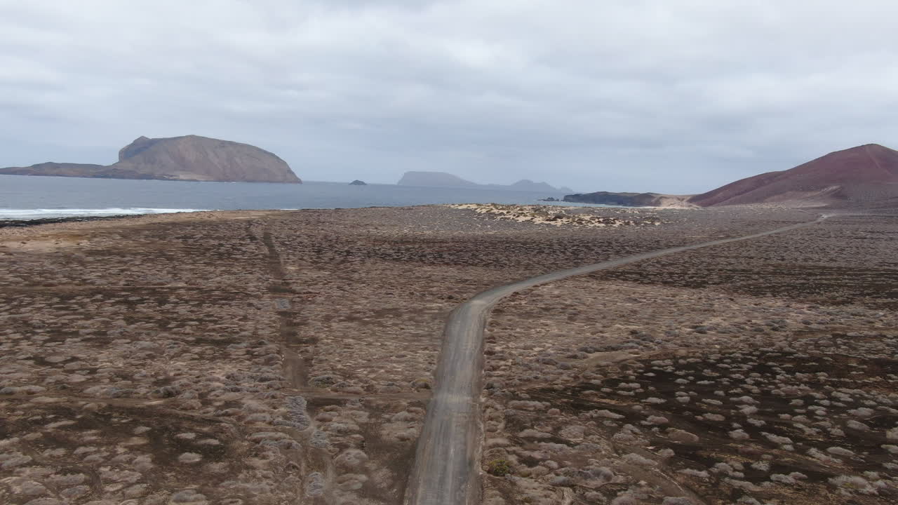 Aerial view of a desert island coast with a road