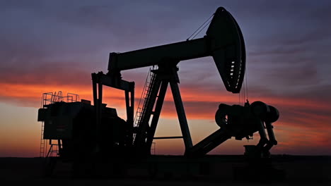 oil pump jack silhouette at sunset