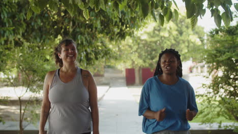 Front-view-of-body-positive-women-jogging-in-park