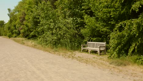 Lonely-bench-amidst-greenery-on-a-race-track-at-the-historic-Hippodrome-de-Boitsfort-track-in-Brussels