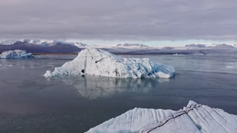 an breathtaking aerial perspective captures the serene yet dynamic beauty of jökulsárlón, iceland's famous glacial lagoon