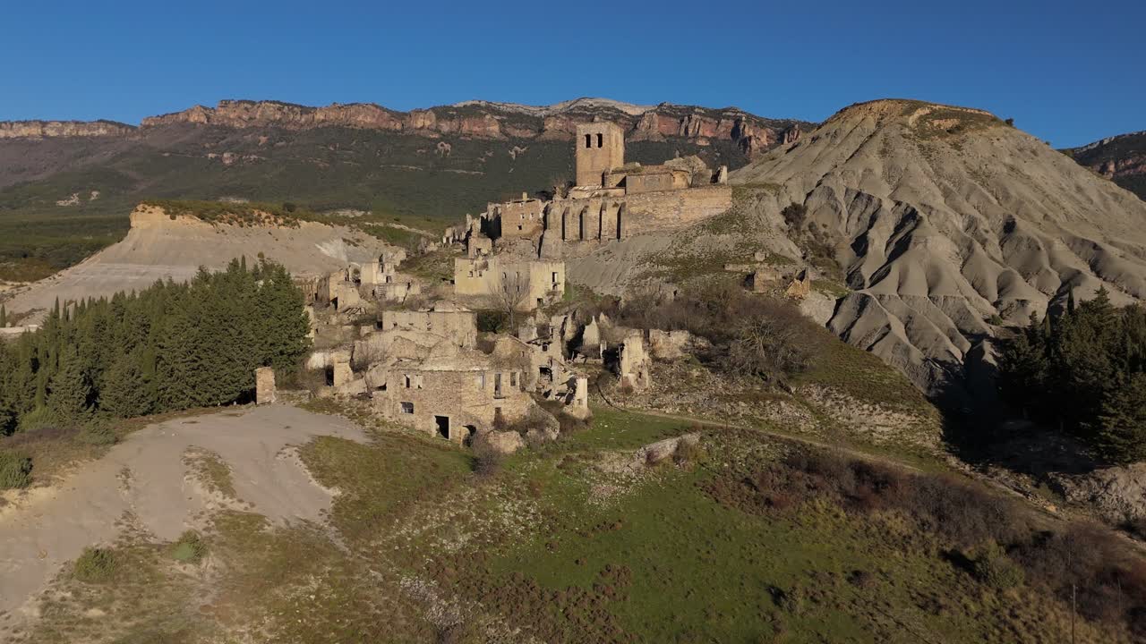 Ascending drone movement and revealing the abandoned village of Esc&oacute;, Spain