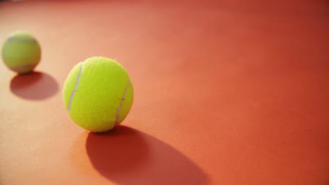 Tennis-ball-bouncing-on-red-floor-4k