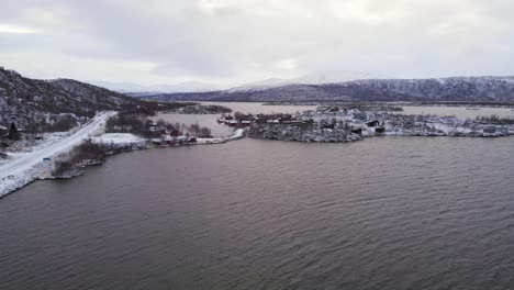 lake side road of norwegian border cross in vasterbotten county, sweden - aerial fly-over shot