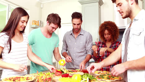 smiling friends making pizza together